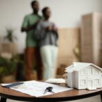 new-home-keys-plan-table-with-defocused-couple