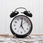 alarm-clock-us-dollar-currency-notes-